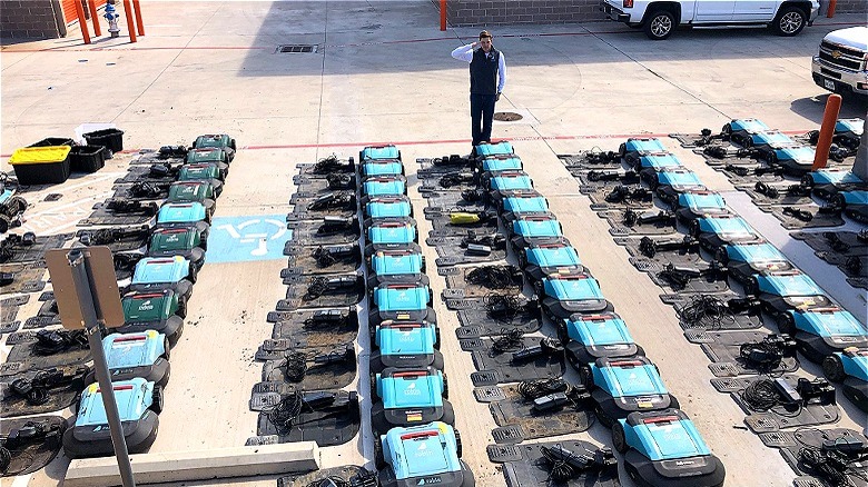 Robotic lawnmowers arranged in parking lot