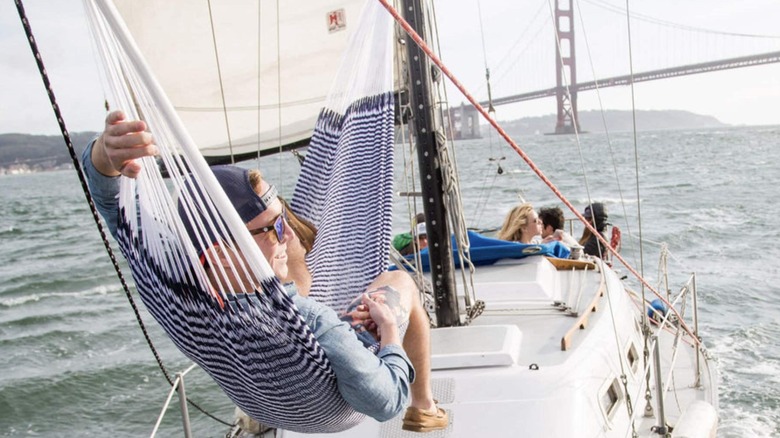 man using Yellow Leaf hammock on boat