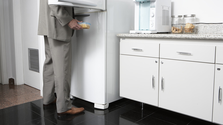 Man looking in white freezer