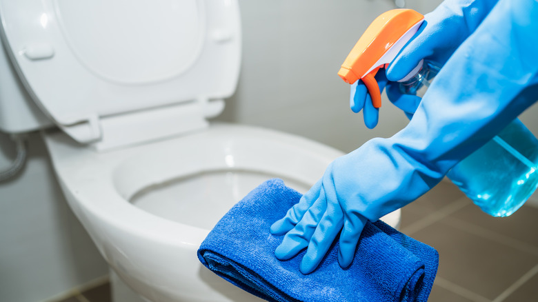 person cleaning a toilet