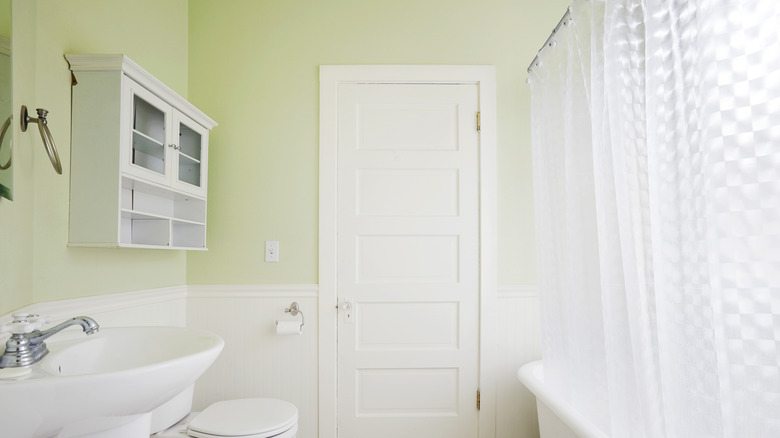 A white shower curtain in the bathroom