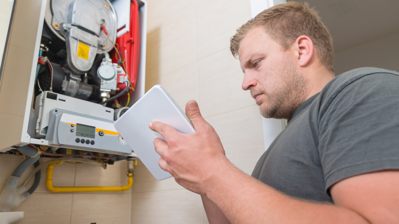 technician fixing furnace