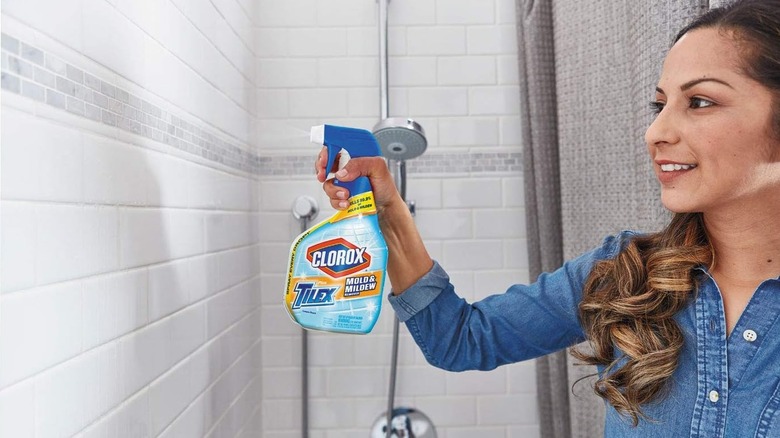 Woman using Clorox spray in shower