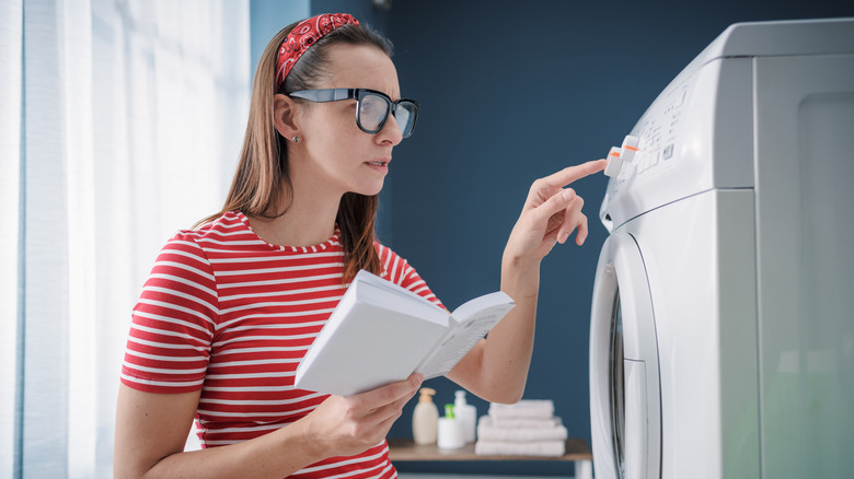 Woman reading a dryer manual