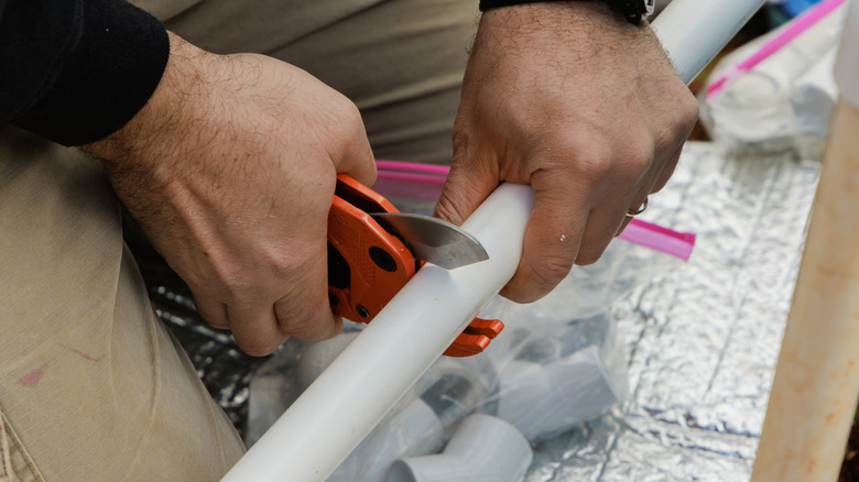 Cutting PVC pipe with a special pipe cutting tool