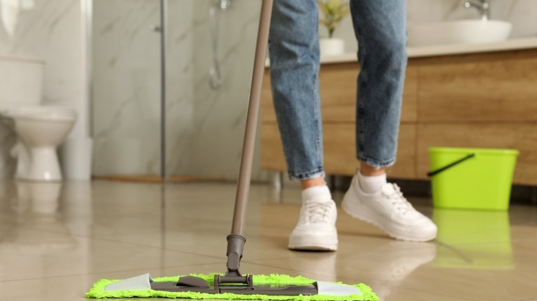 Woman cleaning tile floor 
