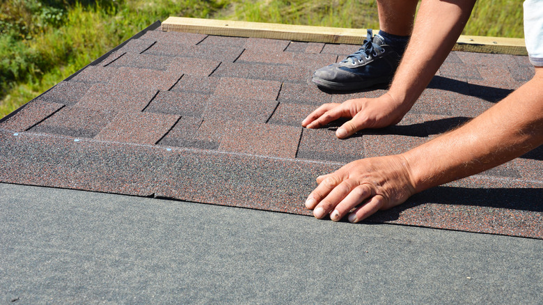 roofer installing shingles