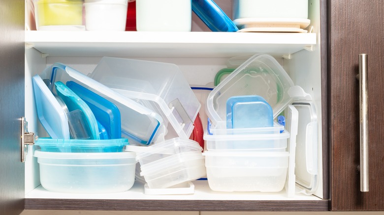 Plastic food containers in cabinet