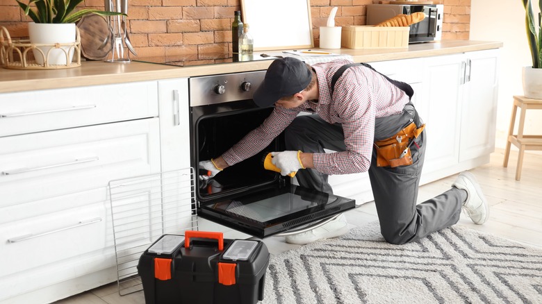 technician repairing oven