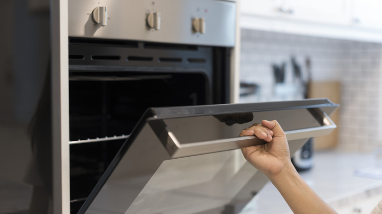 woman opening an oven