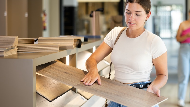 Woman touching flooring planks