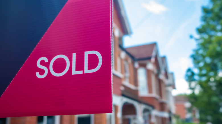 Sold sign in front of houses