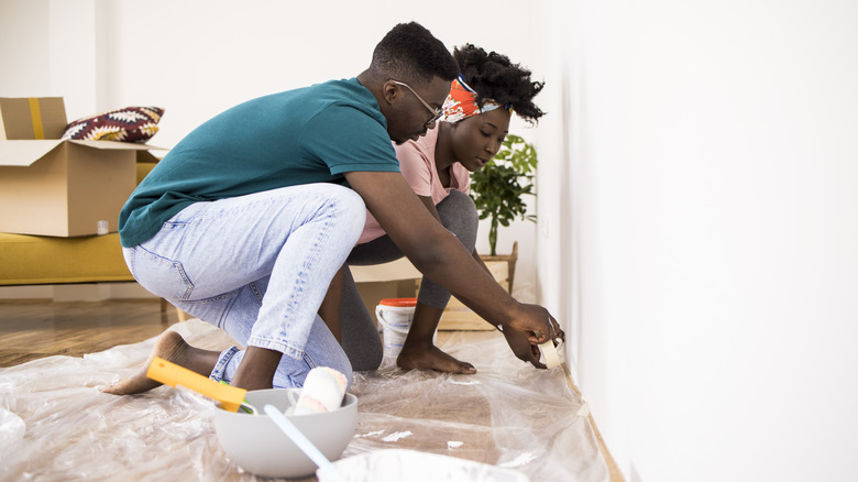 couple prepping painting area