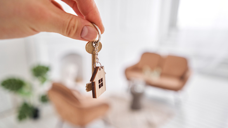 hand holding a house key