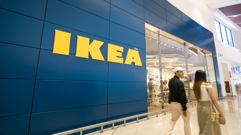 Man and woman walking next to IKEA store