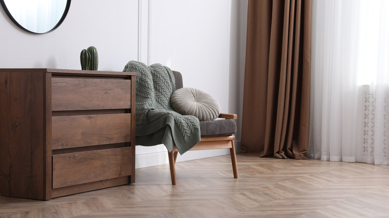 dresser and chair in room