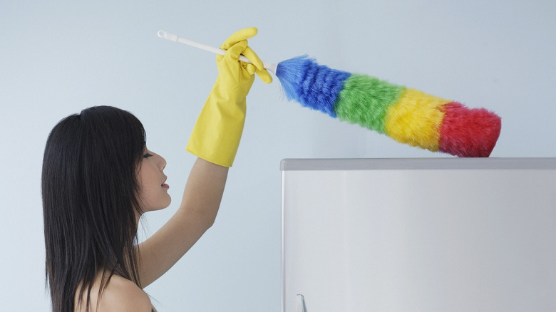 Dusting top of refrigerator