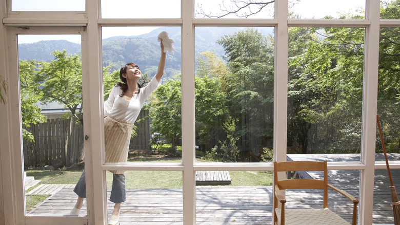 Woman wiping patio windows