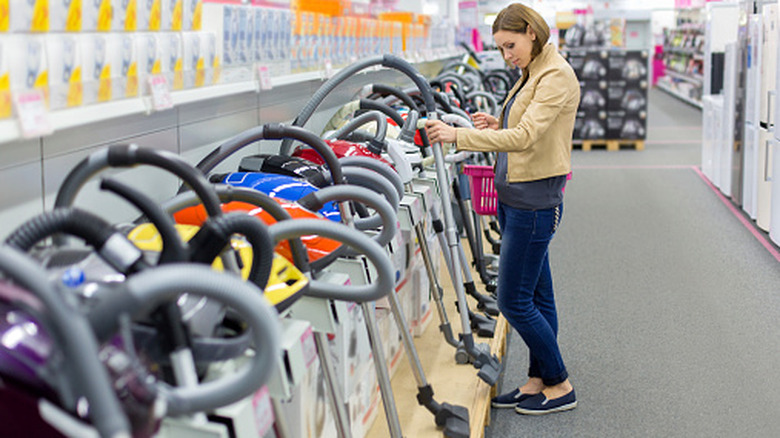 A woman shopping for a vacuum