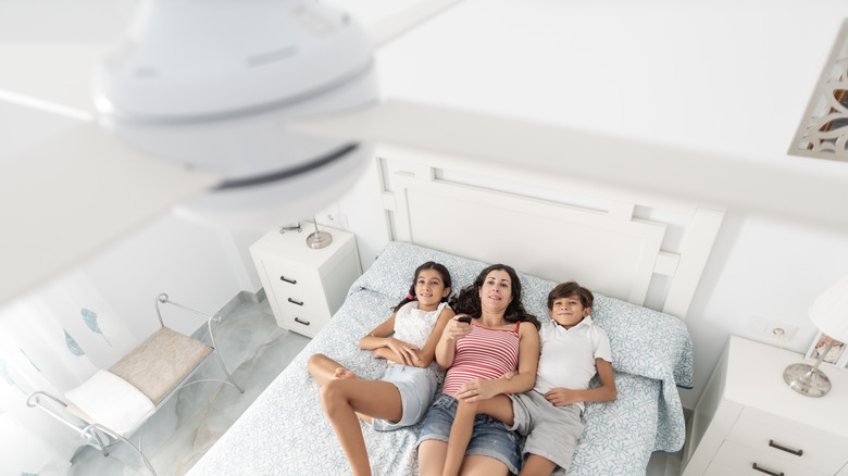 Family under ceiling fan