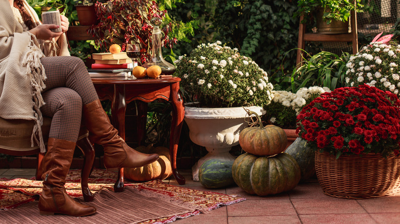 Woman sitting on fall garden porch