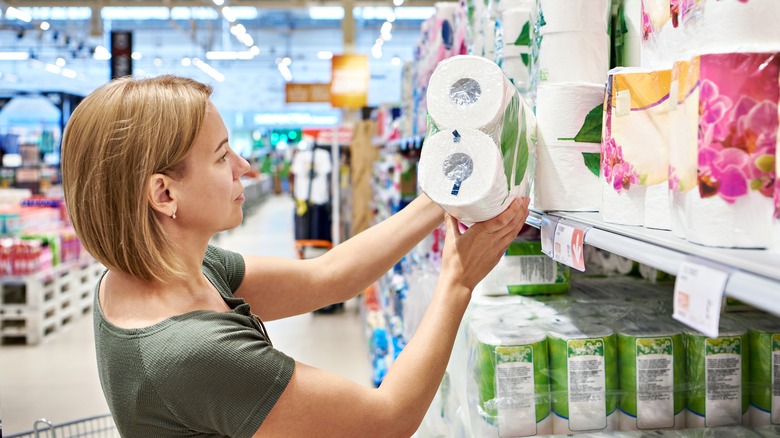 Woman buying toilet paper