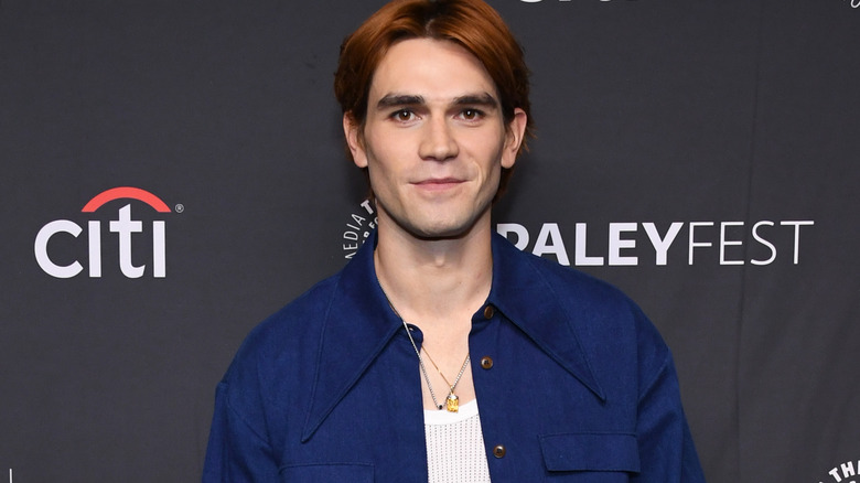 KJ Apa smirking