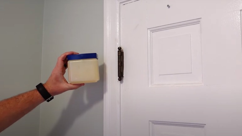 Petroleum jelly on door hinge