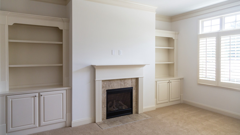 White fireplace with empty shelves