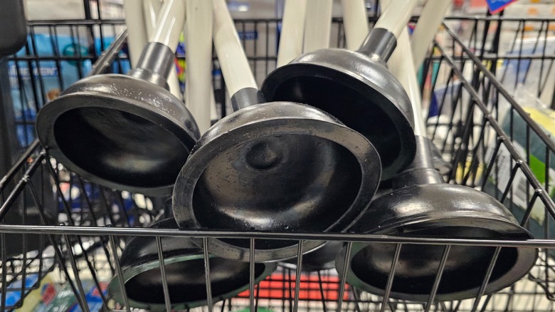 Toilet plungers in a metal basket