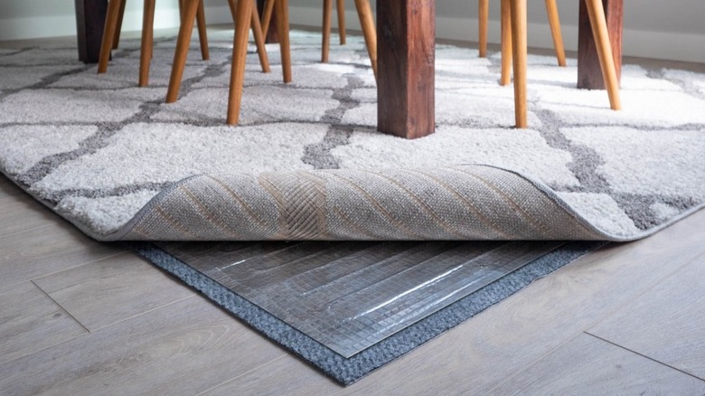 Photo of a CozyWinter heating rug pad, insulation pad, and area rug under a table and chairs