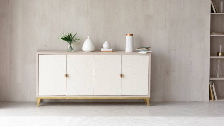 A living room with a white credenza against the wall