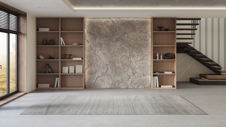 A living room has floor-to-ceiling bookcases