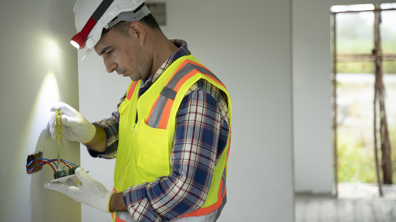 Electrician working with wires in a home