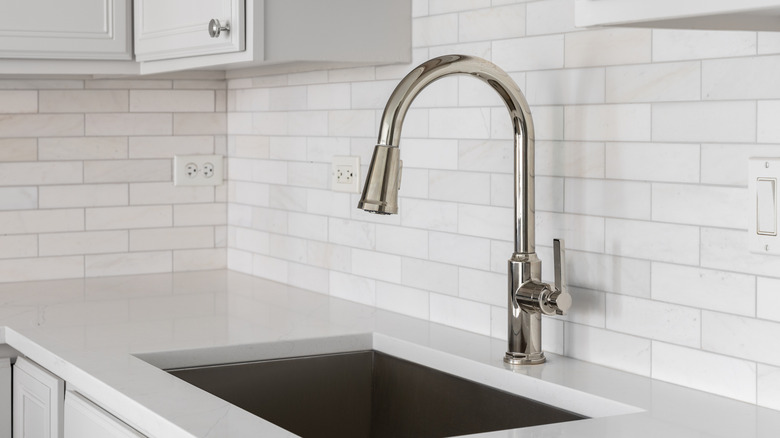 A kitchen backsplash features horizontal electrical outlets