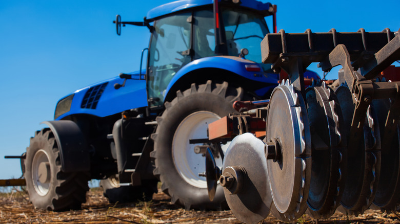 Tractor clears sunflower field