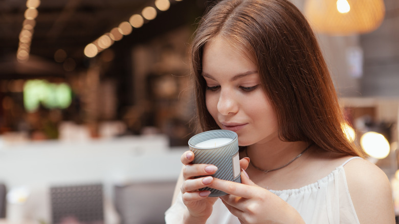 person smelling scented candle