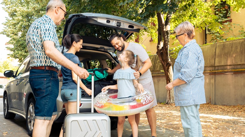 Family arriving at beach house