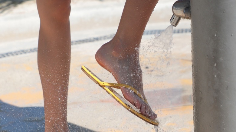 Woman rinsing sand off feet