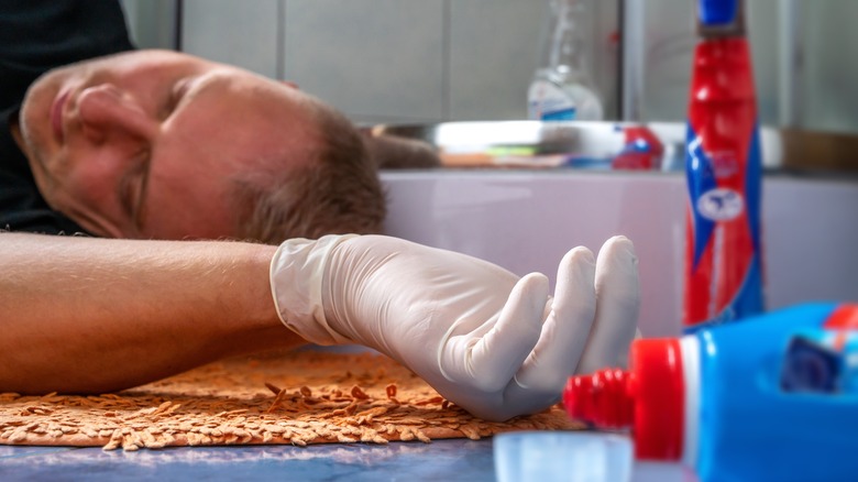 Unconscious man and cleaning products