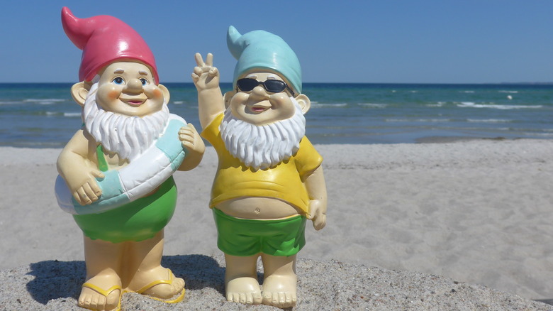 Two garden gnomes on beach