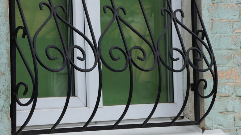 A close-up photo of a window grill shows the curved feature and intricate design elements