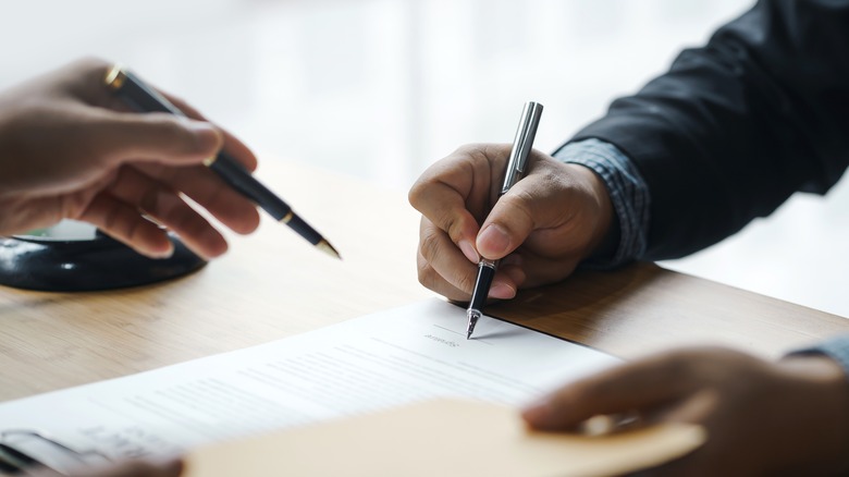 People signing mortgage documents