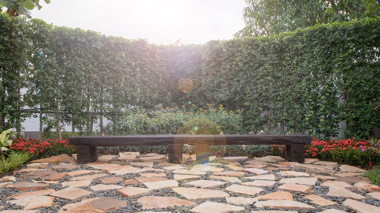 Flagstone patio with wood bench