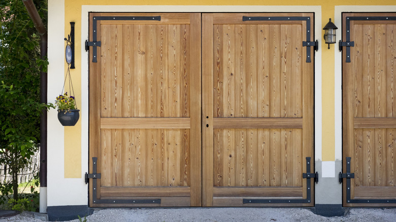 Wooden garage door with decorative metal detailing