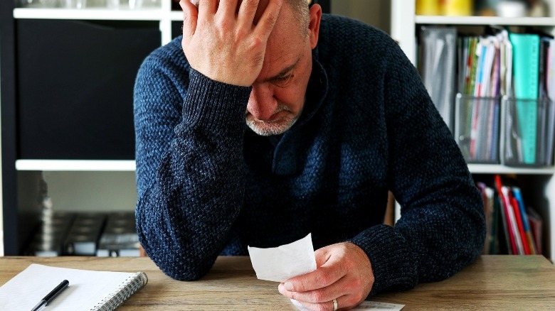 Man contemplating his expenses