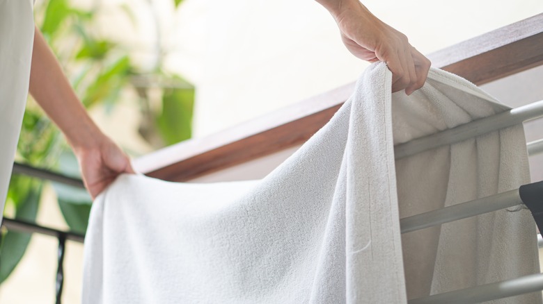 woman hanging towel to dry