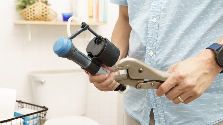 Man using wrench on fill valve