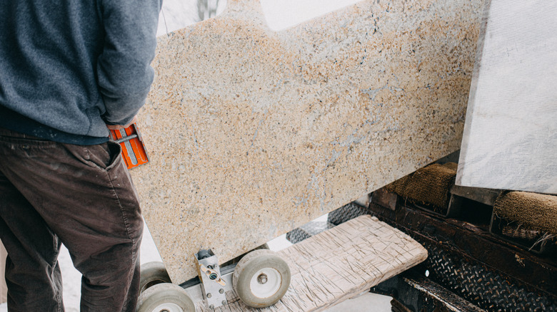 Workers bringing in countertop section