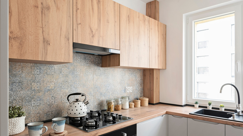 A small, cozy kitchen with wood cabinets